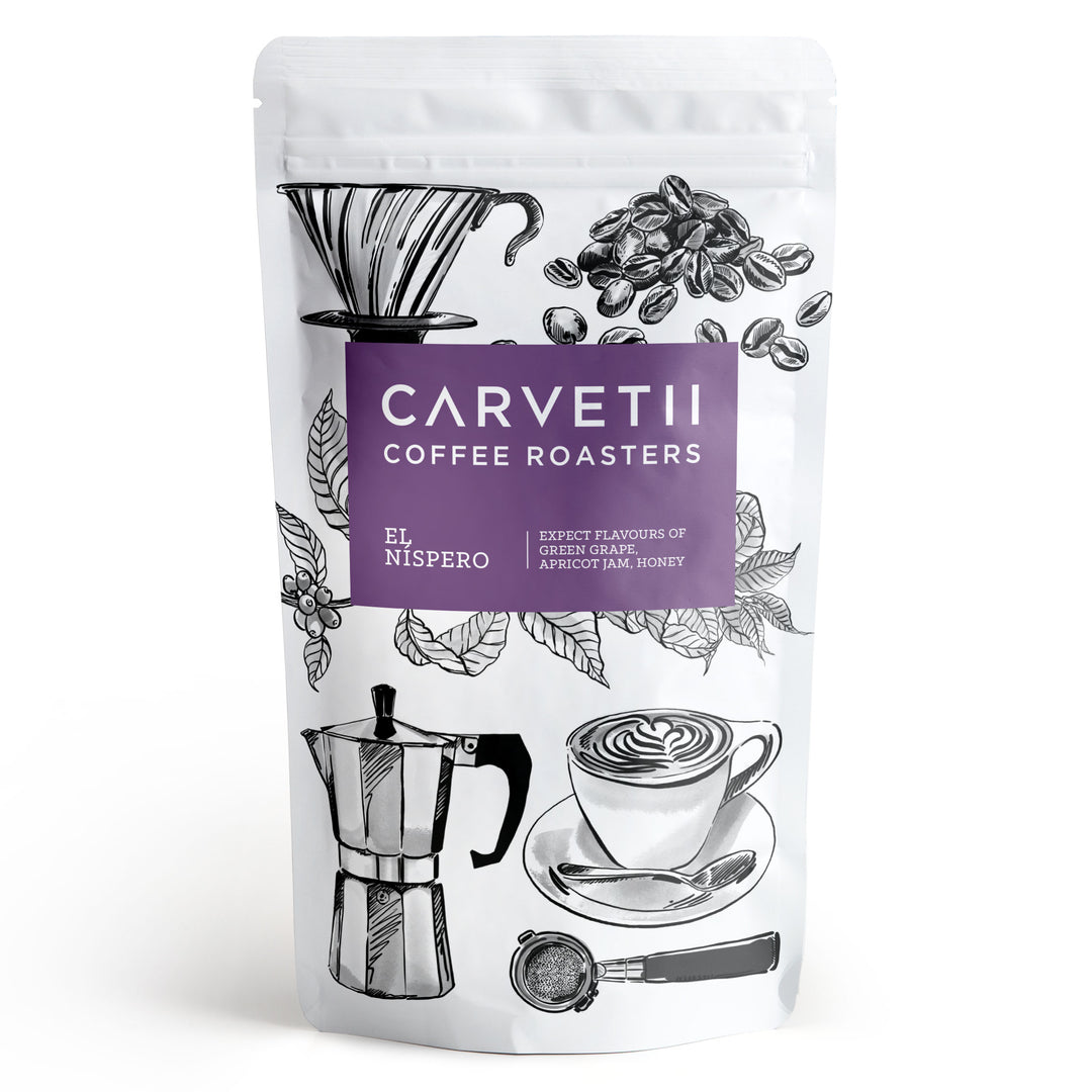 Carvetii Coffee Roasters El Nispero coffee in a white stand-up pouch with a purple label and black coffee-related illustrations.